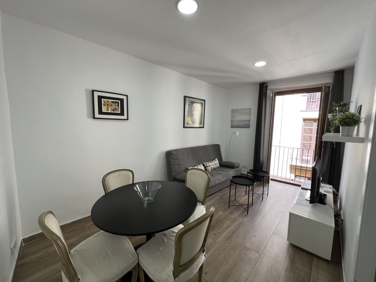 Spacious bedroom with parquet floor, louvred wardrobe and two windows